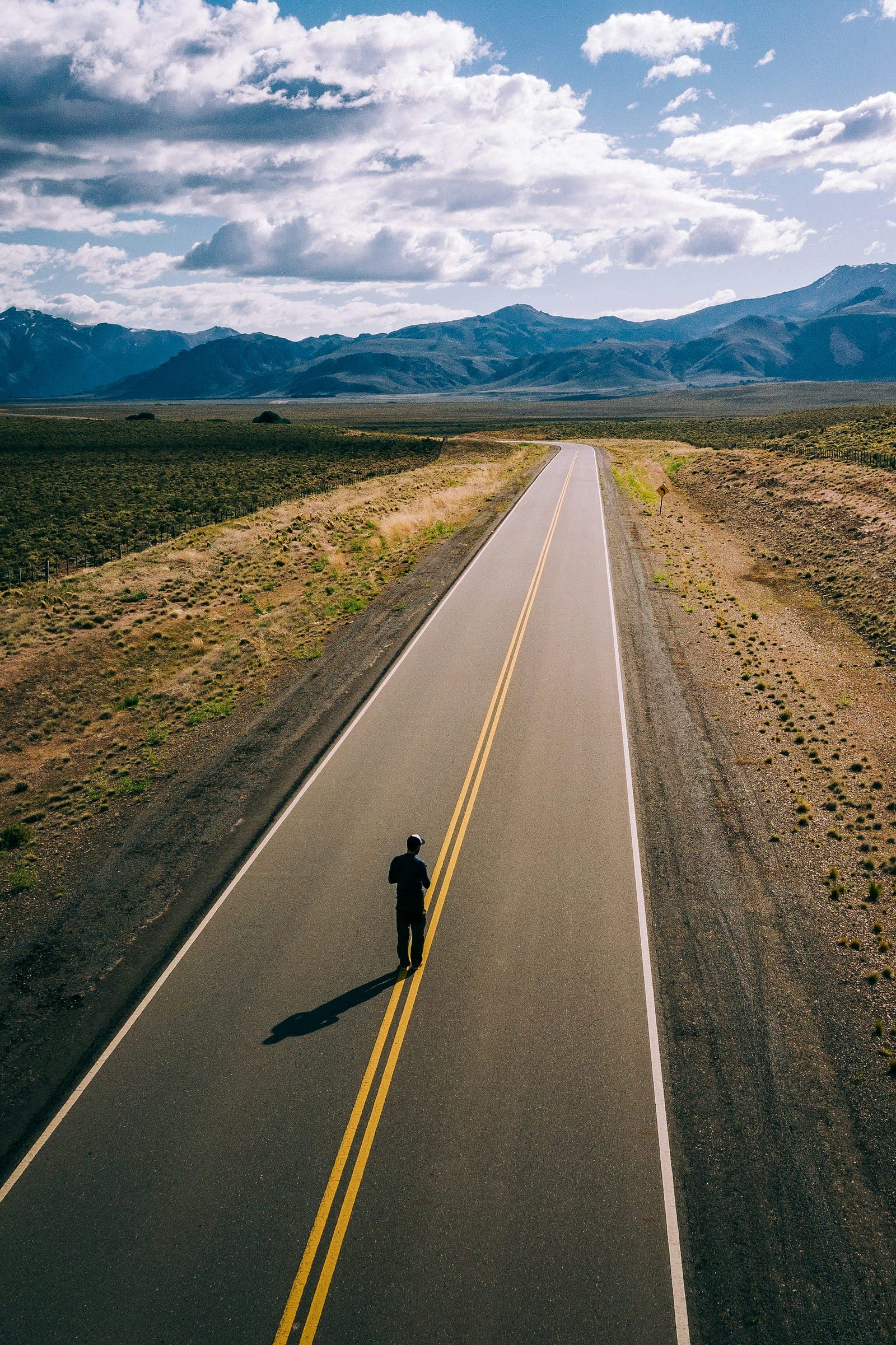 A person running on a road at sunrise